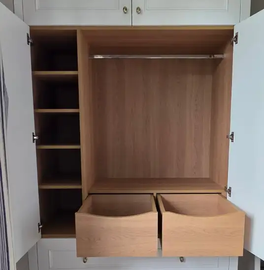 Inside a wardrobe with oak shelves, hanging rail and two deep drawers
